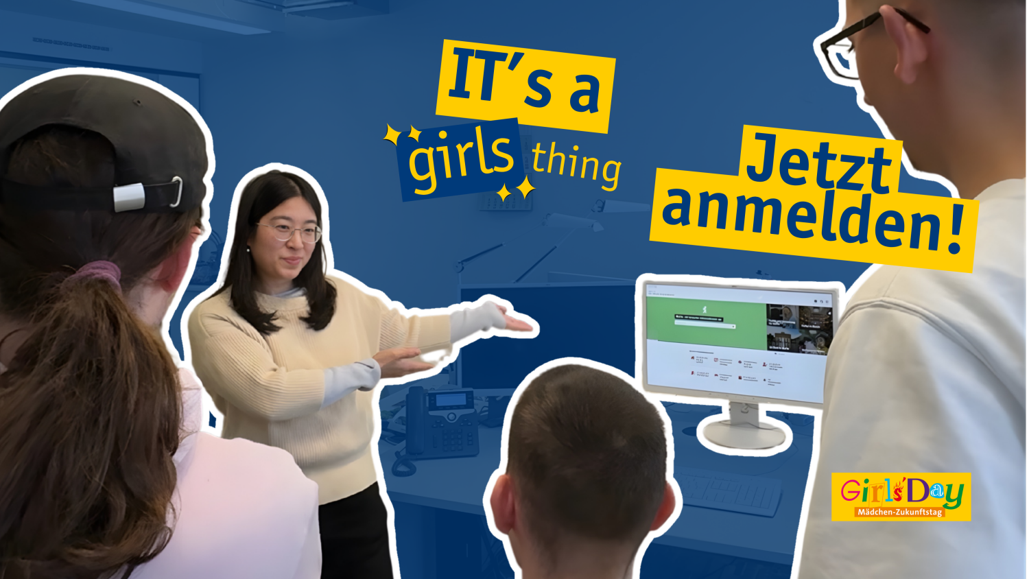 Eine Büroszene: Drei Jugendliche stehen ratlos vor einem technischen Problem am Computer. Sie holen ihre junge Kollegin dazu, die das Problem im Handumdrehen schnell löst.