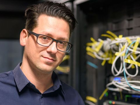Mitarbeitender an einem Serverschrank