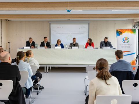 Beteiligte vom BWAS Programm sitzen an einem Tisch und sprechen über das Projekt