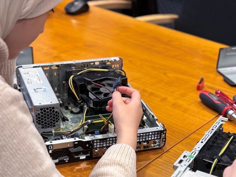 Mädchen schraubt an offenem Rechner